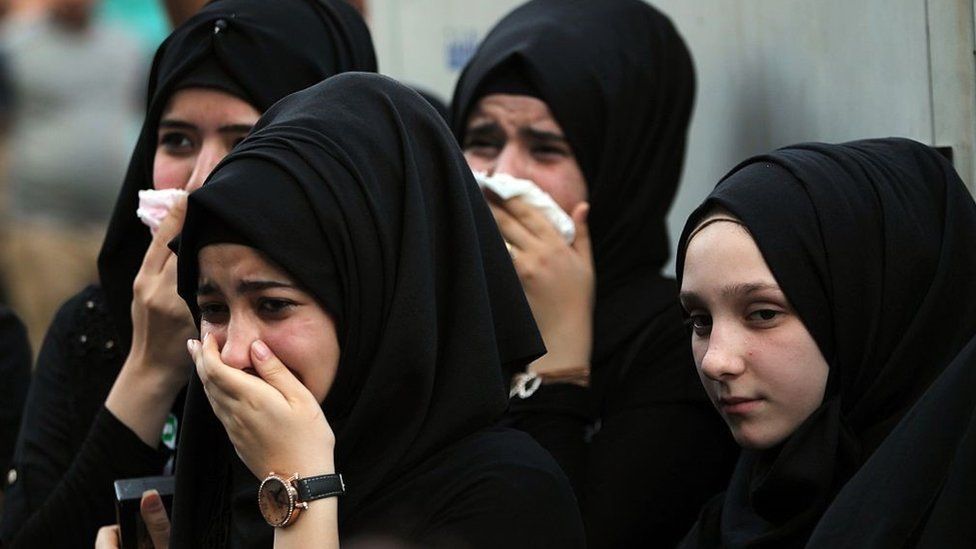 Иракские женщины скорбят на месте взрыва в багдадском районе Каррада во время символических похорон жертв теракта 10 июля 2016 г.