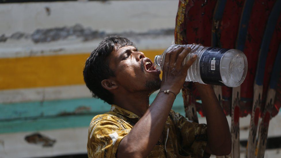 A man in Dhaka drinks water amid a heatwave