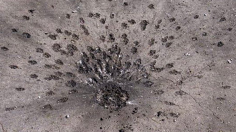 An apparent submunition impact from a cluster bomb in a Kharkiv residential neighbourhood