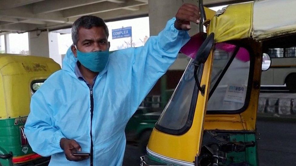 Raj Kumar next to his "tuk-tuk ambulance"