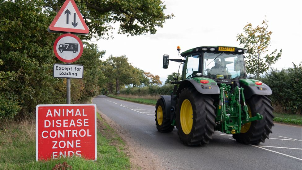 tractor passing bird flu restriction sign