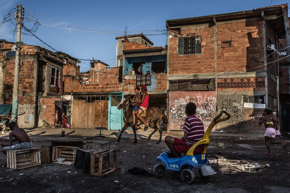 Boys riding on their work horse at Favela Vila do Metrô community, Mangueira, Rio de Janeiro, Brazil.