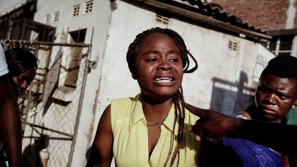 A girl cries after being allegedly beaten as soldiers disperse demonstrators in Harare on 1 August 2018