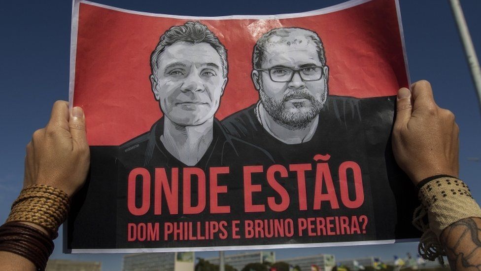 A poster with photos of Dom Phillips and Bruno Pereira