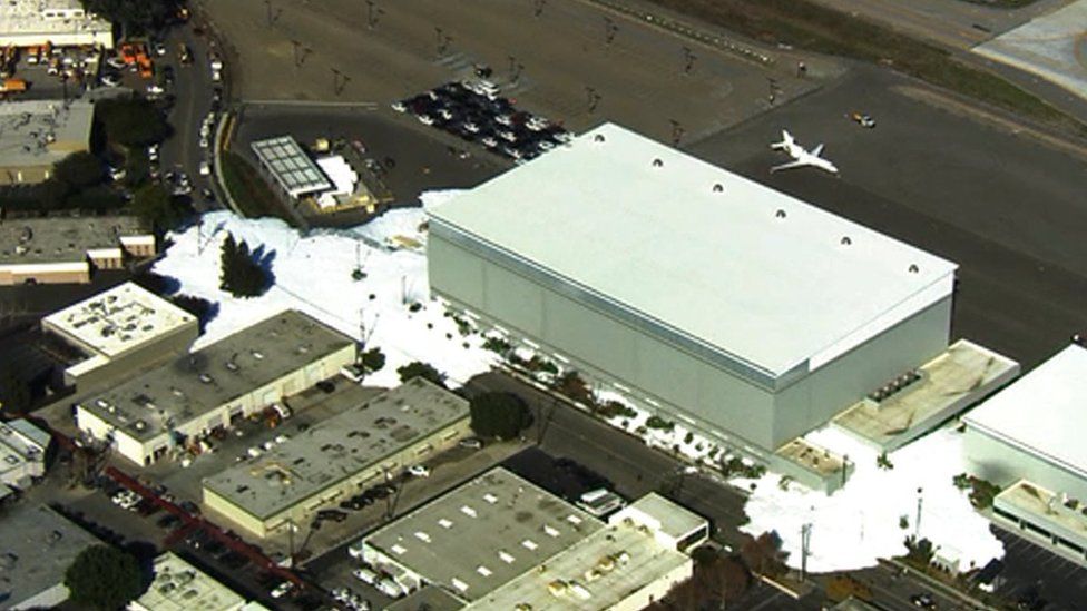 In this image provided courtesy of KTVU-TV, foam spills out of a hanger building at the Mineta San Jose International Airport, Friday, Nov. 18, 2016, in San Jose, Calif.