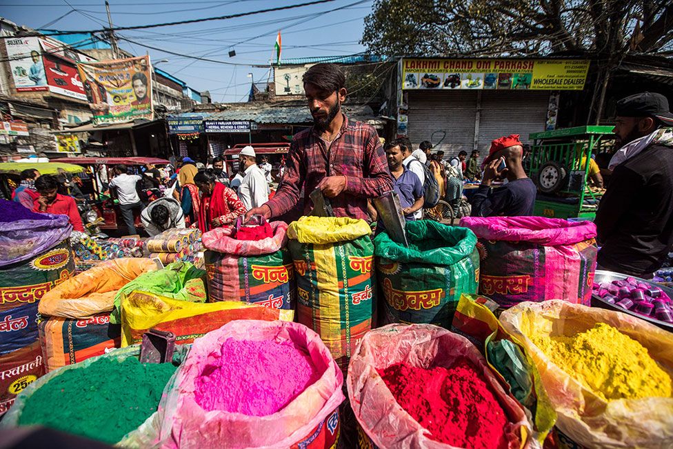 A vendor sells coloured powder for the forthcoming Hindu festival Holi, at Sadar Bazaar market in the old quarters of New Delhi, India, on 9 March 2022