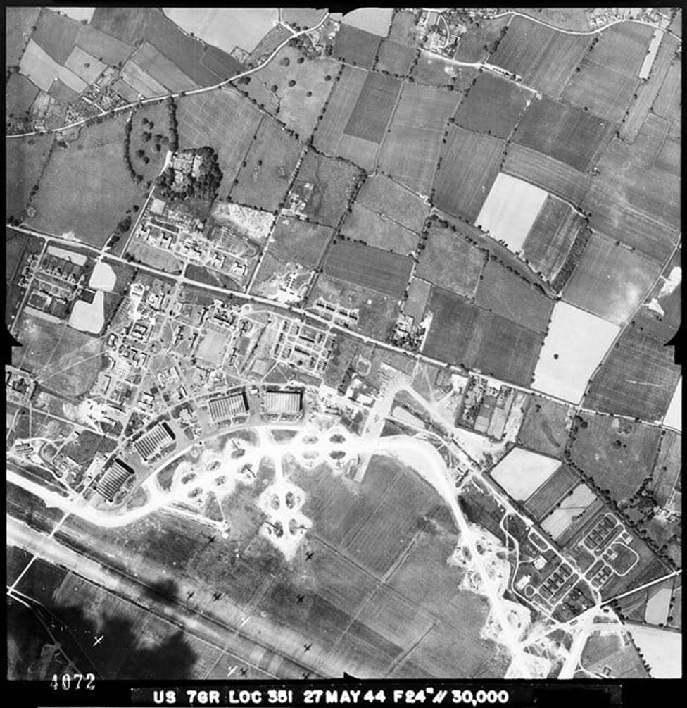The shadows of USAAF bomber aircraft in flight dot the fields at RAF Watton (USAAF Station 376), Norfolk, 27 May 1944.