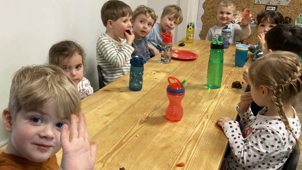 children at a table with snacks