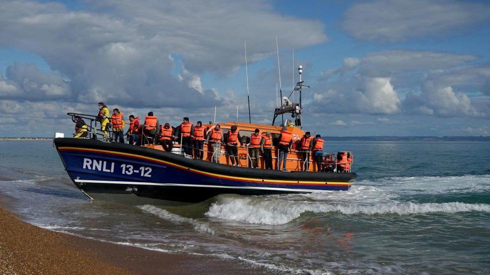 A photo showing people thought to be migrants arriving on the Kent coast in September