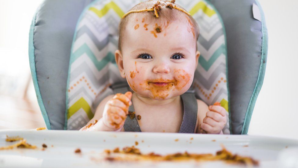 Baby covered in food