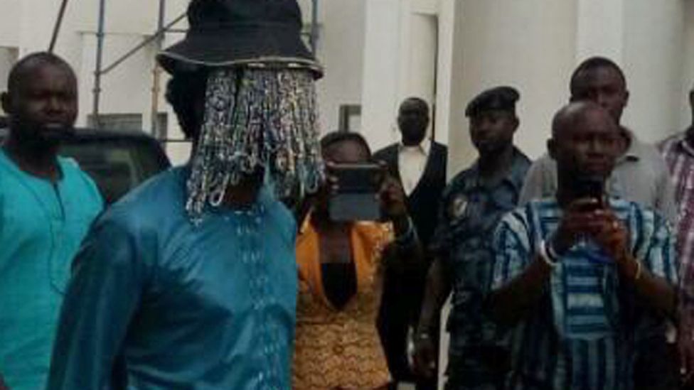 Anas Aremeyaw Anas with beads hiding his face