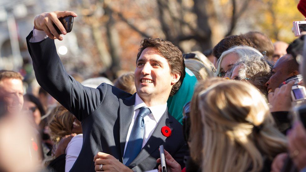 Canadian Prime Minister Justin Trudeau taking selfies with fans