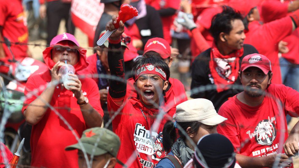 Red Shirt supporters of former PM Thaksin Shinawatra chant slogans at a television satellite centre on 9 April 2010 in Bangkok, Thailand