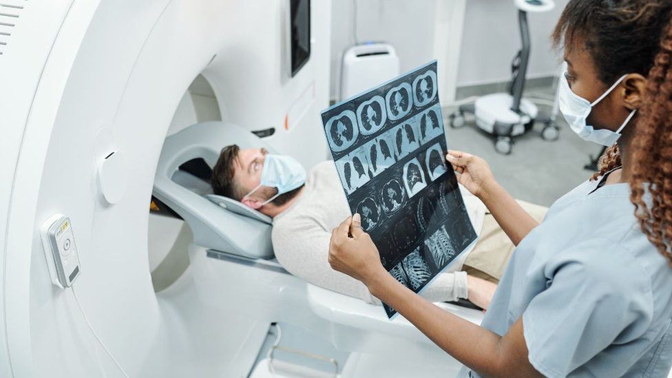 Doctor looks at scan images