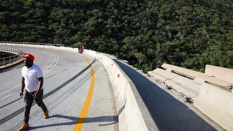 A man walks past part of the bridge damaged in a deadly bus accident in Limpopo, South Africa.