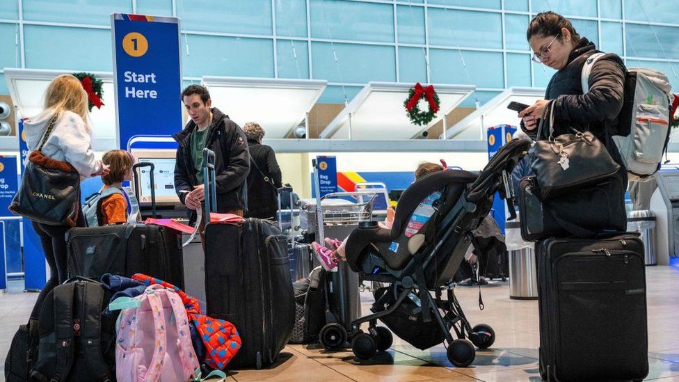 Passengers check-in for their flights at Baltimore/Washington International Thurgood Marshall Airport in Linthicum, Maryland, on November 21, 2023, ahead of the Thanksgiving holiday