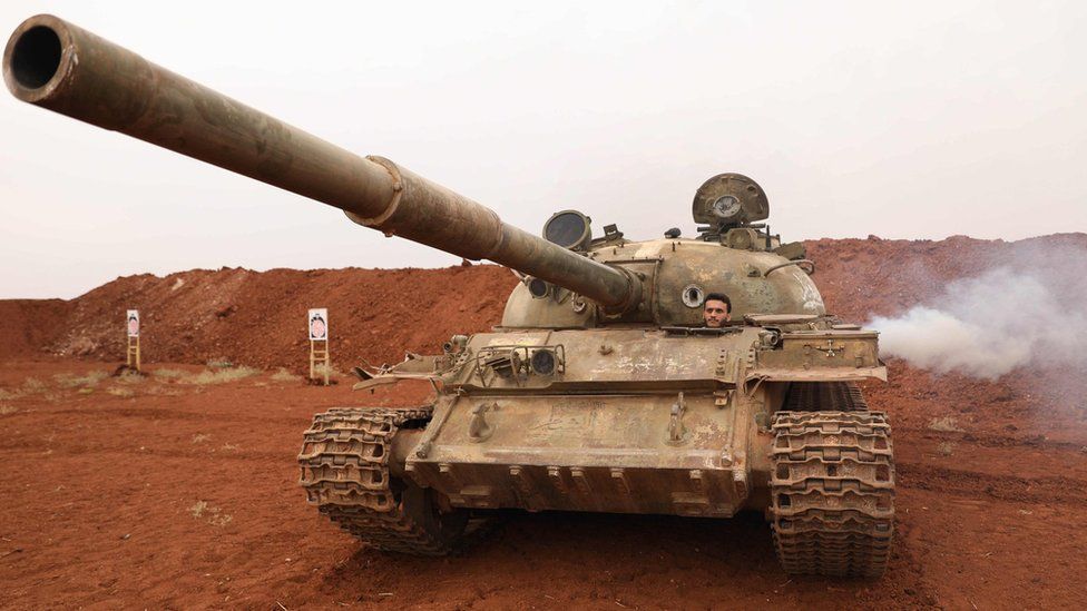 Syrian rebel fighter drives a tank that was withdrawn from a demilitarised zone along the front line in Idlib province (9 October 2018)