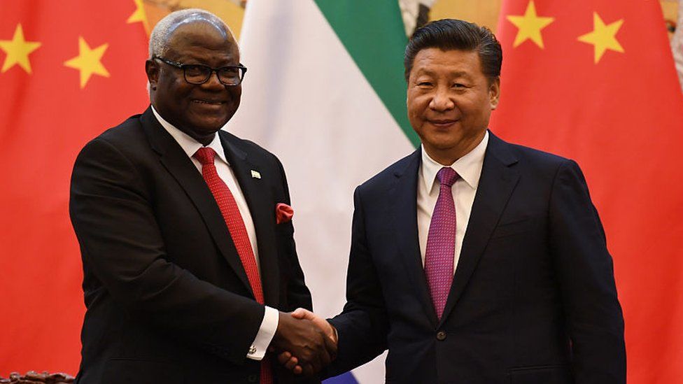 Former Sierra Leone President Ernest Bai Koroma (L) and Chinese President Xi Jinping shake hands during a signing ceremony in Beijing's Great Hall of the People on December 1, 2016.
