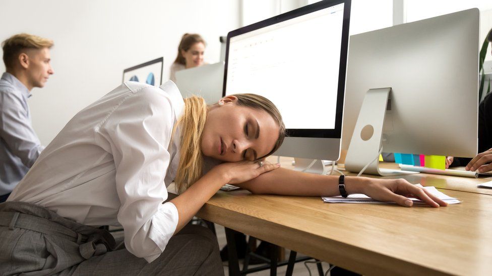 Woman asleep on a desk