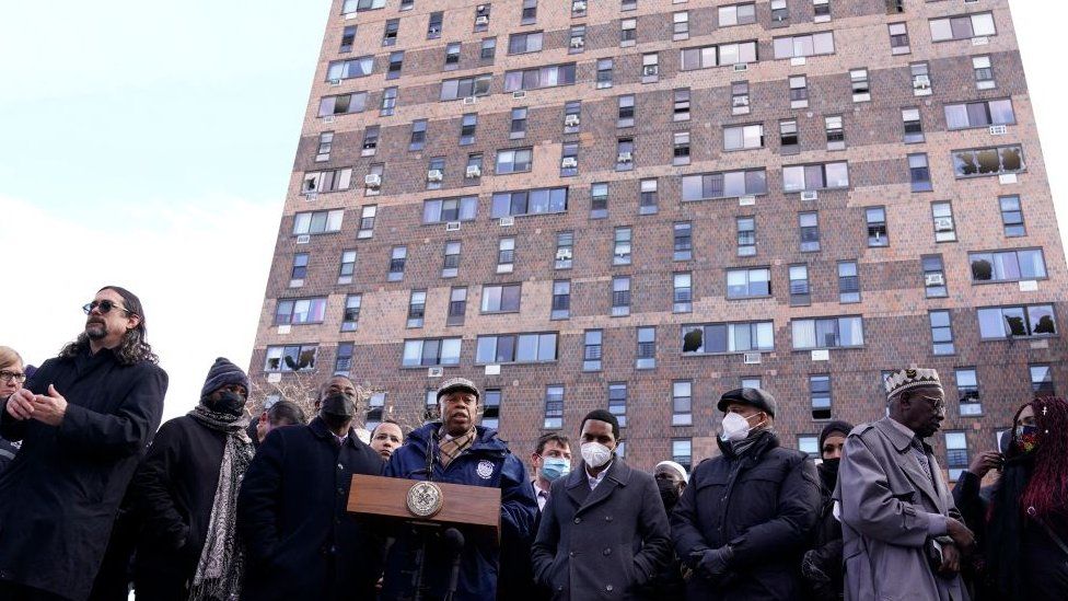 New York City Mayor Eric Adams holds a press conference 10 January 2022 outside the 120-unit apartment building in the Bronx that was the site of the fire yesterday