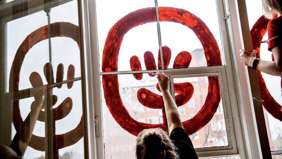 Women painting windows for International Women's Day in Copenhagen