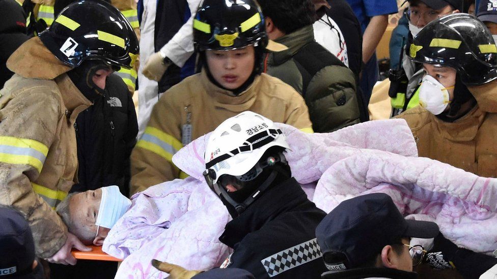 Rescue workers remove a survivor from a hospital fire on 26 January 2018 in Miryang, South Korea - handout picture provided by Kim Gu Yeon/Gyeongnam Domin Ilbo