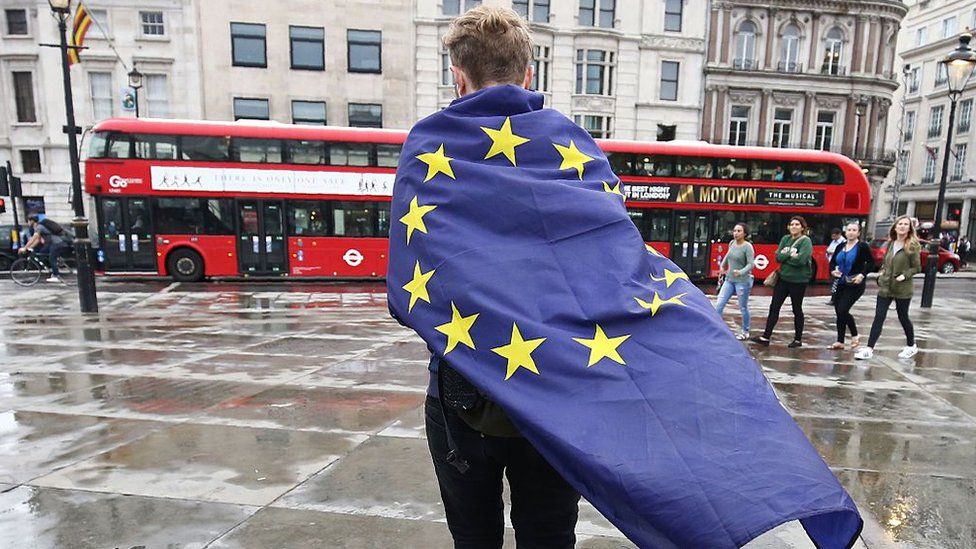 A demonstrator wrapped in a European flag leaves an anti-Brexit protest in Trafalgar Square in central London