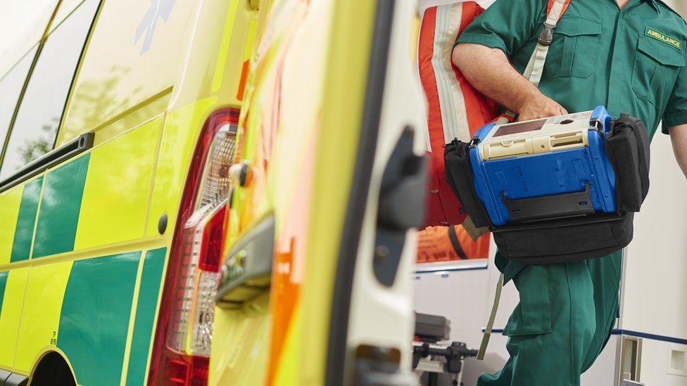 A generic image of an ambulance worker stepping out of a vehicle