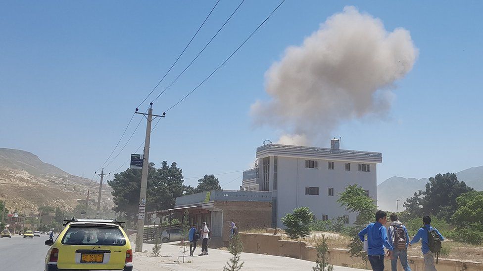 A plume of smoke rises from a building in northern Afghanistan during a Taliban attack