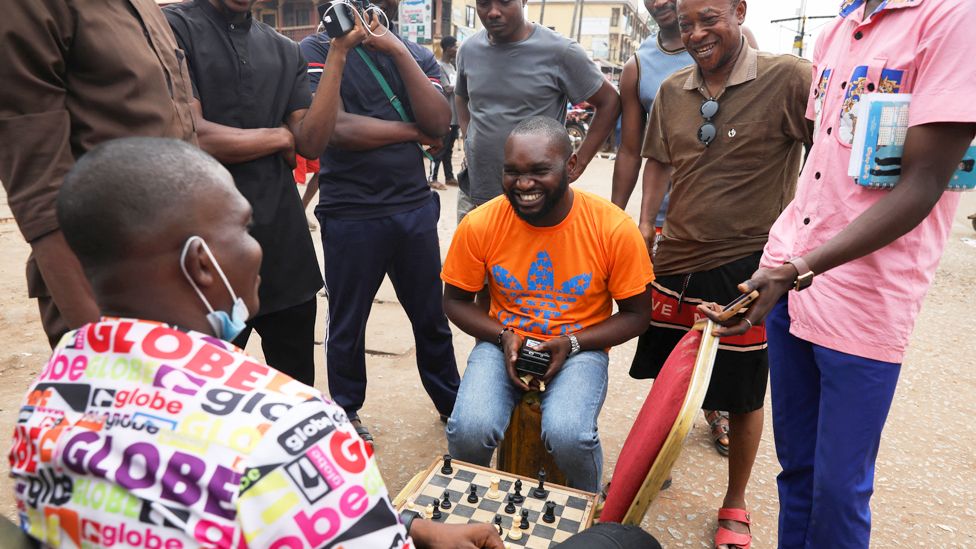 Men playing chess at a polling station in Awka, Anambra state, Nigeria - Saturday 25 February 2023