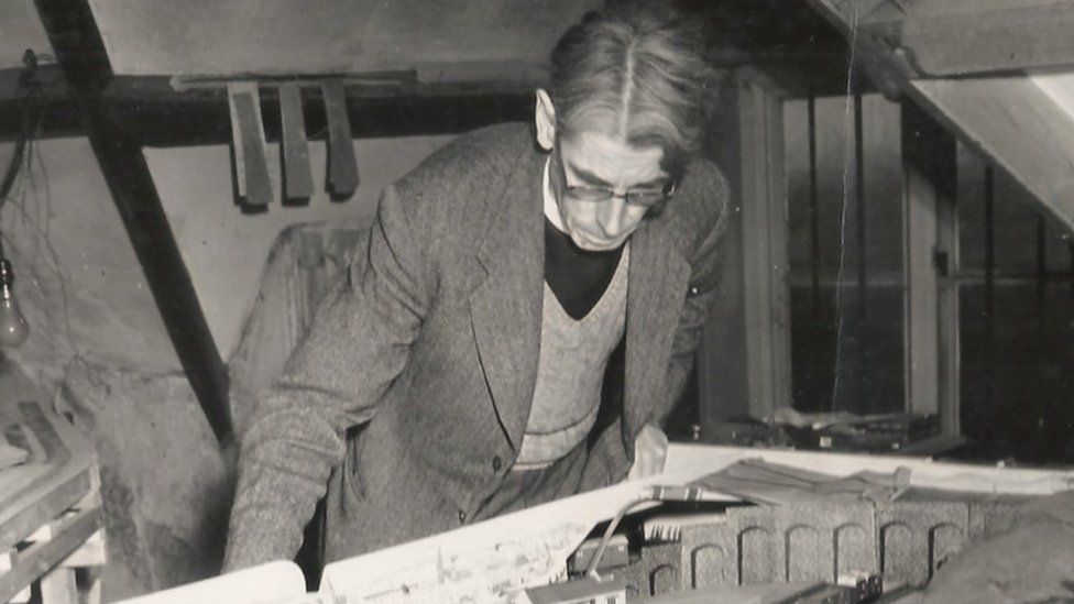 Wilbert Awdry looking down at the railway set he used to help plan his stories