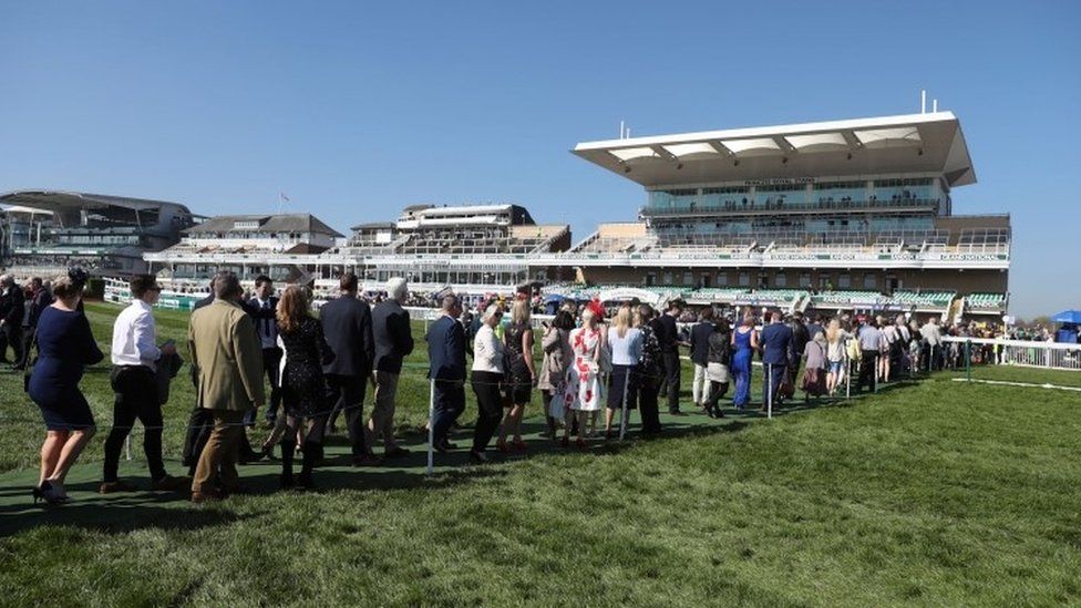 Racegoers arrivefor Grand National Day of the Grand National Festival at Aintree