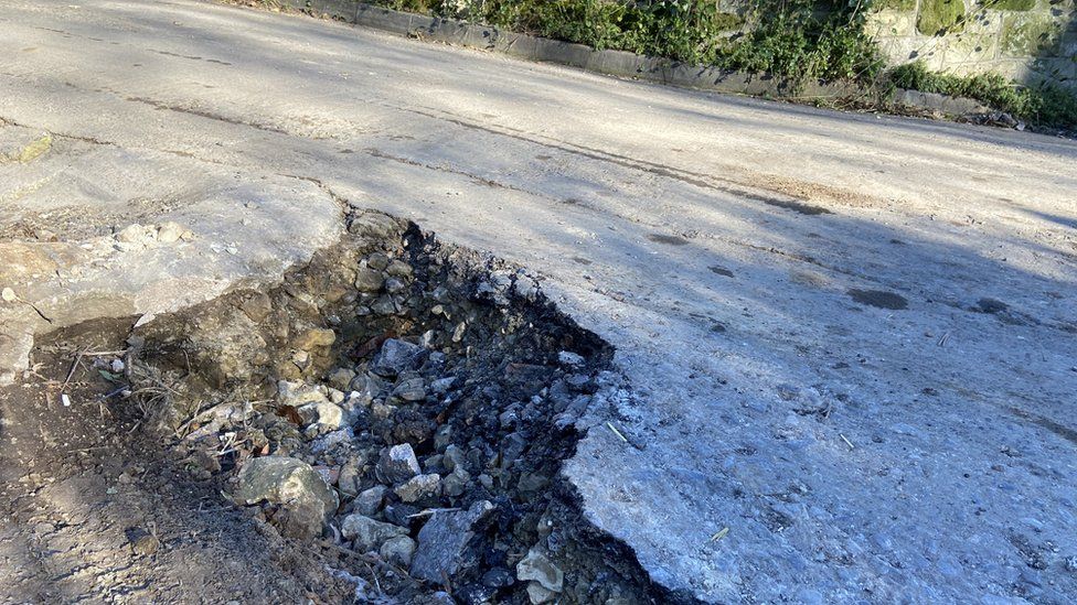 A large pothole in the side of a road in south Wiltshire