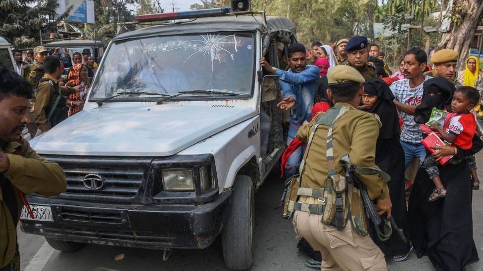 Police personnel take arrested people allegedly involved in child marriages to present before a court in a vehicle as their relatives react, near Mayong police station in Morigaon district of Assam on February 4, 2023.