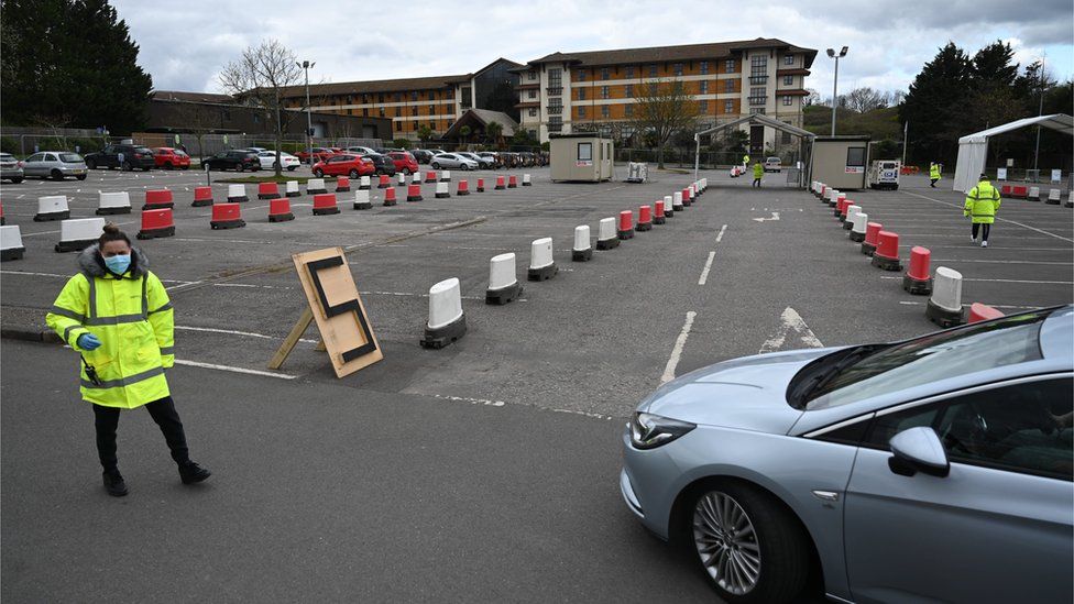 A car arrives at an NHS coronavirus drive through testing facility at Chessington World of Adventure