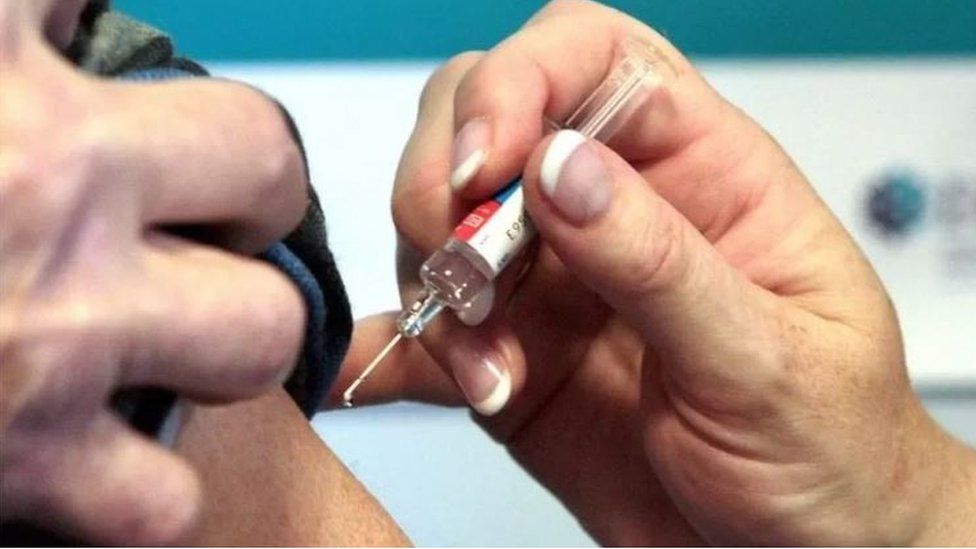A hand holding a needle