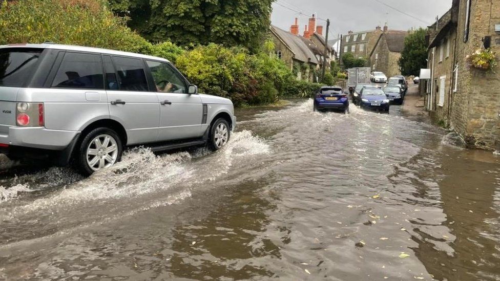 Cars on flooded road in Dorset