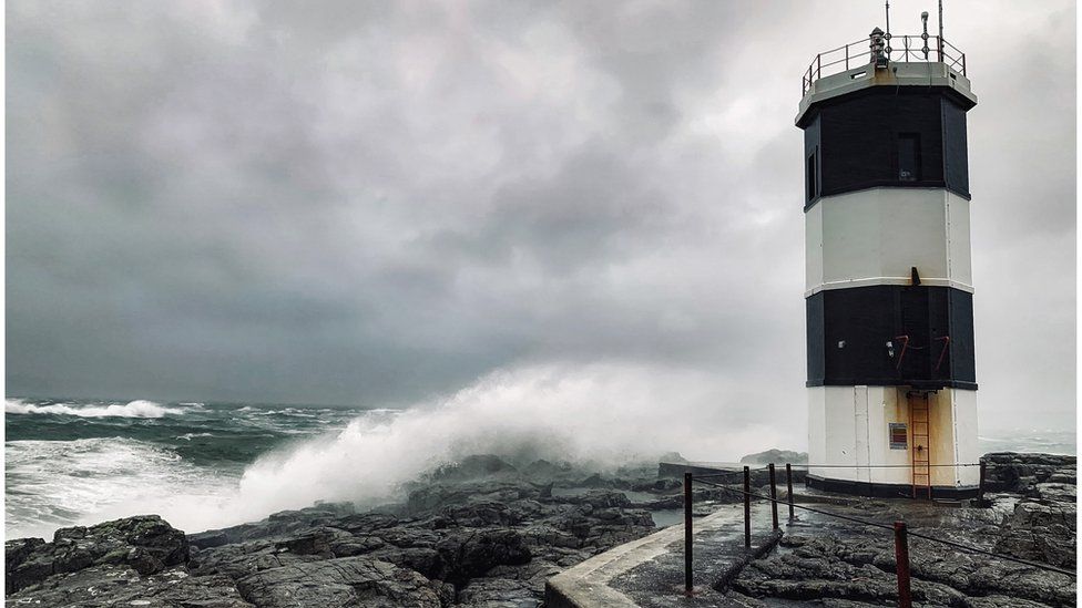 Waves crash on rocks near Rue lighthouse on Rathlin Island