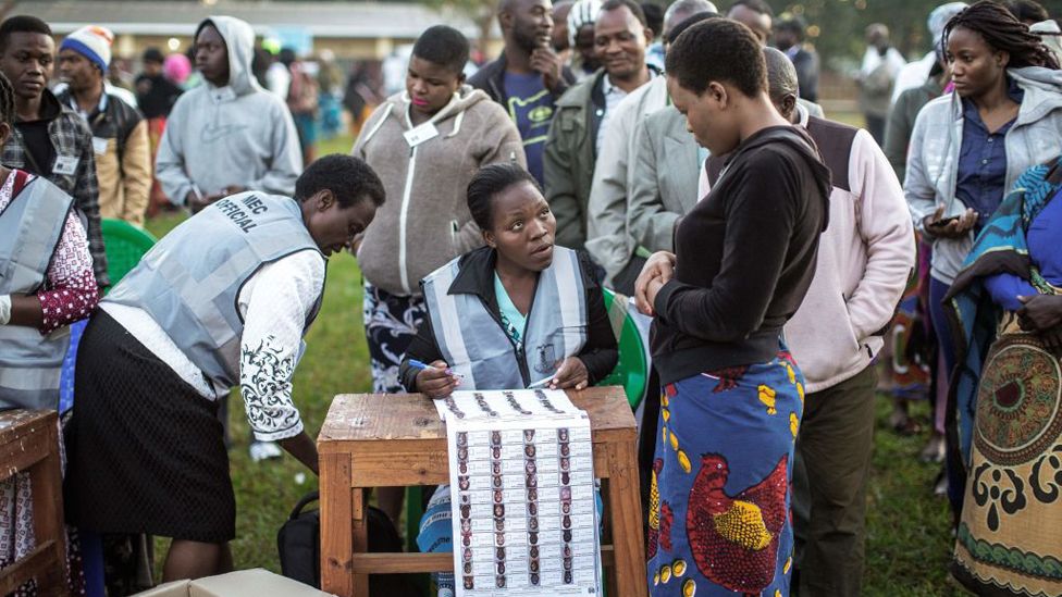 A Malawian Electoral Commission officer checks the voters roll before opening voting stations during general elections on May 21, 2019