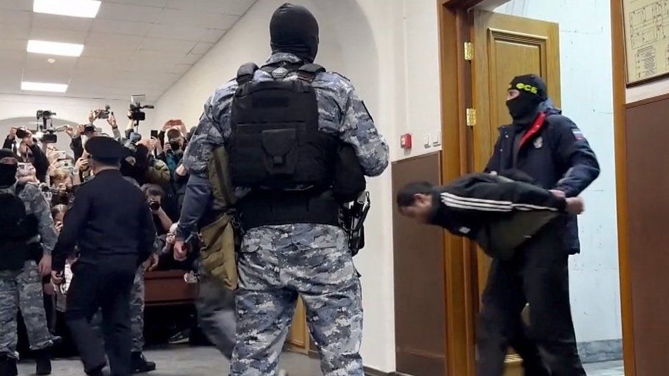 A suspect is brought into court