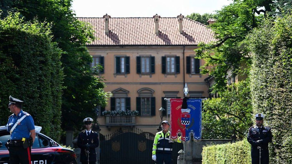 Municipal police stand guard outside Villa San Martino, the residence of Italian businessman and former prime minister Silvio Berlusconi, following his death