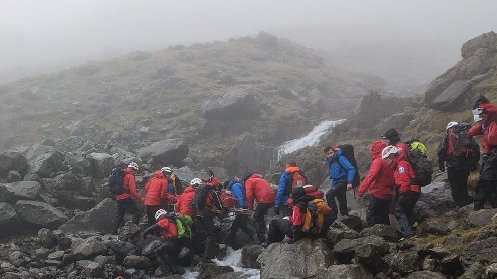 Rescuers help the casualty who was found on the east bank of Piers Gill