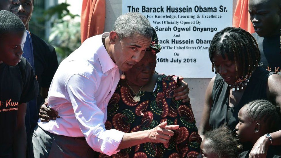 Former US President, Barack Obama (3rdL) with his step-grandmother Sarah (C) and half-sister, Auma (2ndR) and some of the local youth are pictured on July 16, 2018 following the unveiling of a plaque during the opening of the Sauti Kuu Resource Centre, founded by his half-sister, Auma Obama at Kogelo in Siaya county, western Kenya.