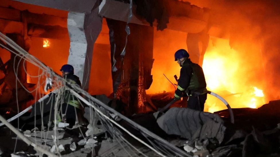 Firefighters in Dnipro after a missile strike on Friday
