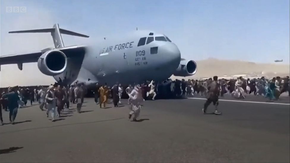 Hundreds of Afghans ran alongside the US Air Force C-17 plane as it moved down the runway at Hamid Karzai International Airport in Kabul