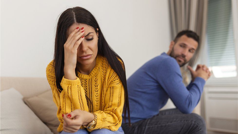 Angry couple on sofa