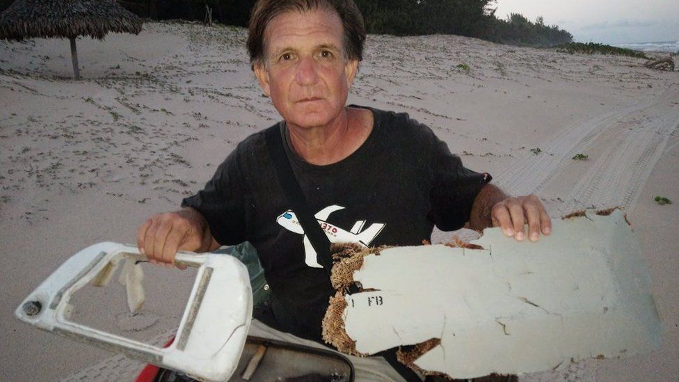 Blaine Gibson showing two pieces of possible MH370 debris found in Madagascar