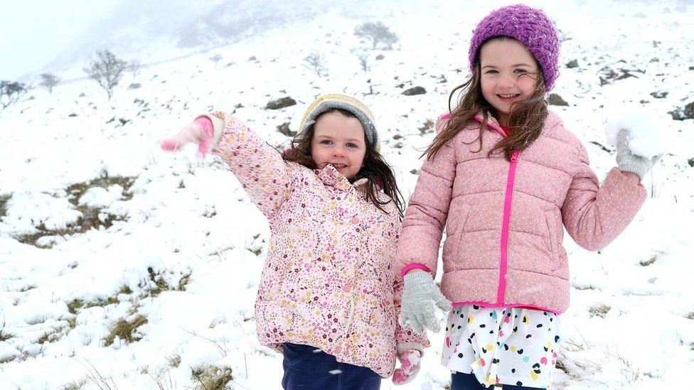 Two girls throw snowballs on Slemish Mountain
