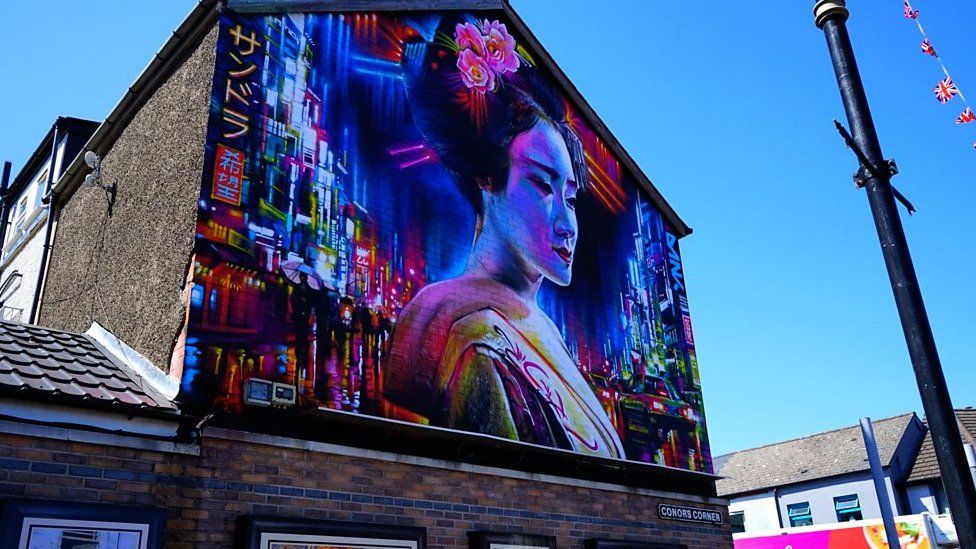A professional mural and street artist has been painting Japanese inspired art in parts of Belfast.