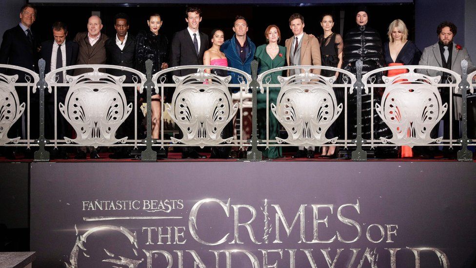 JK Rowling (6th R) surrounded by members of the cast and production team pose for a photograph during the premier of the fantasy film "Fantastic Beasts: The Crimes of Grindelwald" in Paris on November 8, 2018.